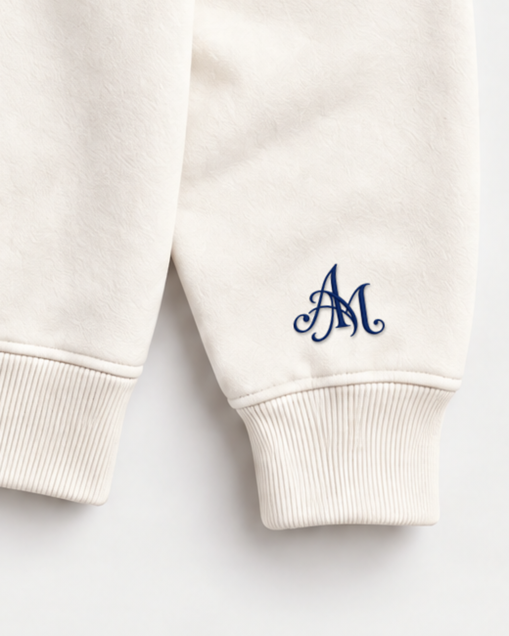 Close-up of the AM monogram on the left sleeve
