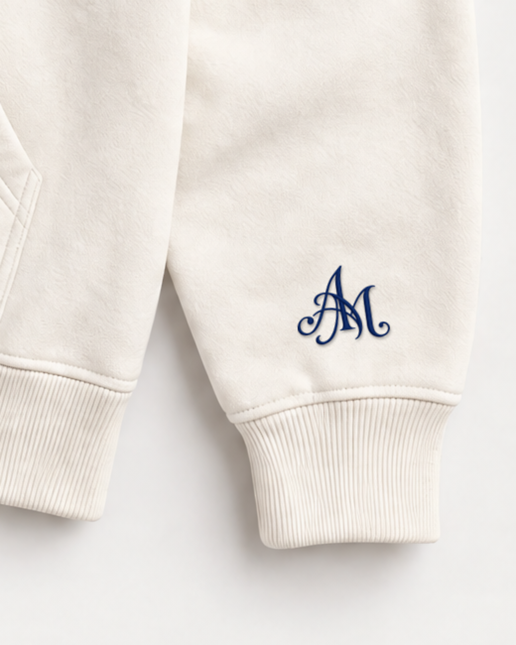 Close-up of the AM monogram on the left sleeve