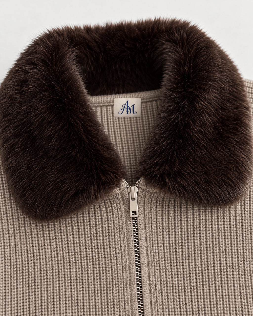 Detail: faux-fur collar and woven AM neck label