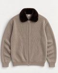 The Engadin Zip Knit in taupe with dark faux-fur collar and woven AM neck label, front view